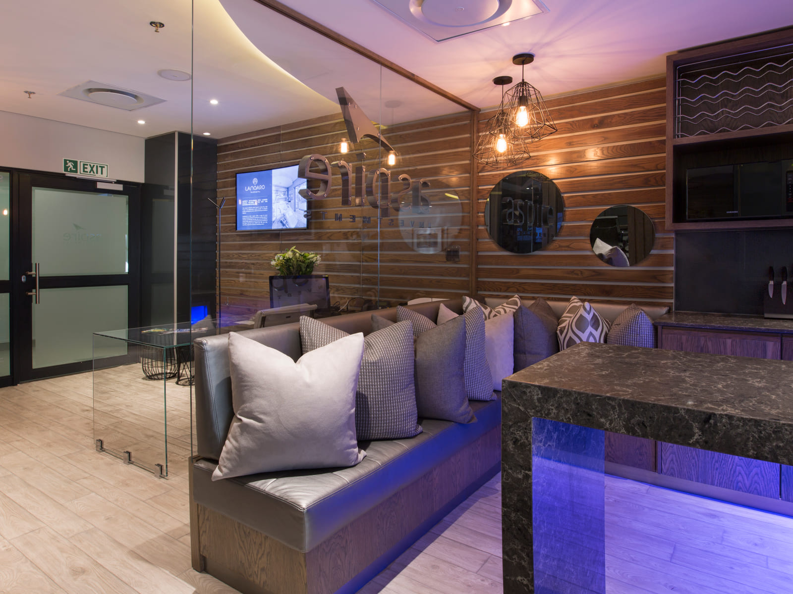 Contemporary office lounge with soft seating and warm timber detailing