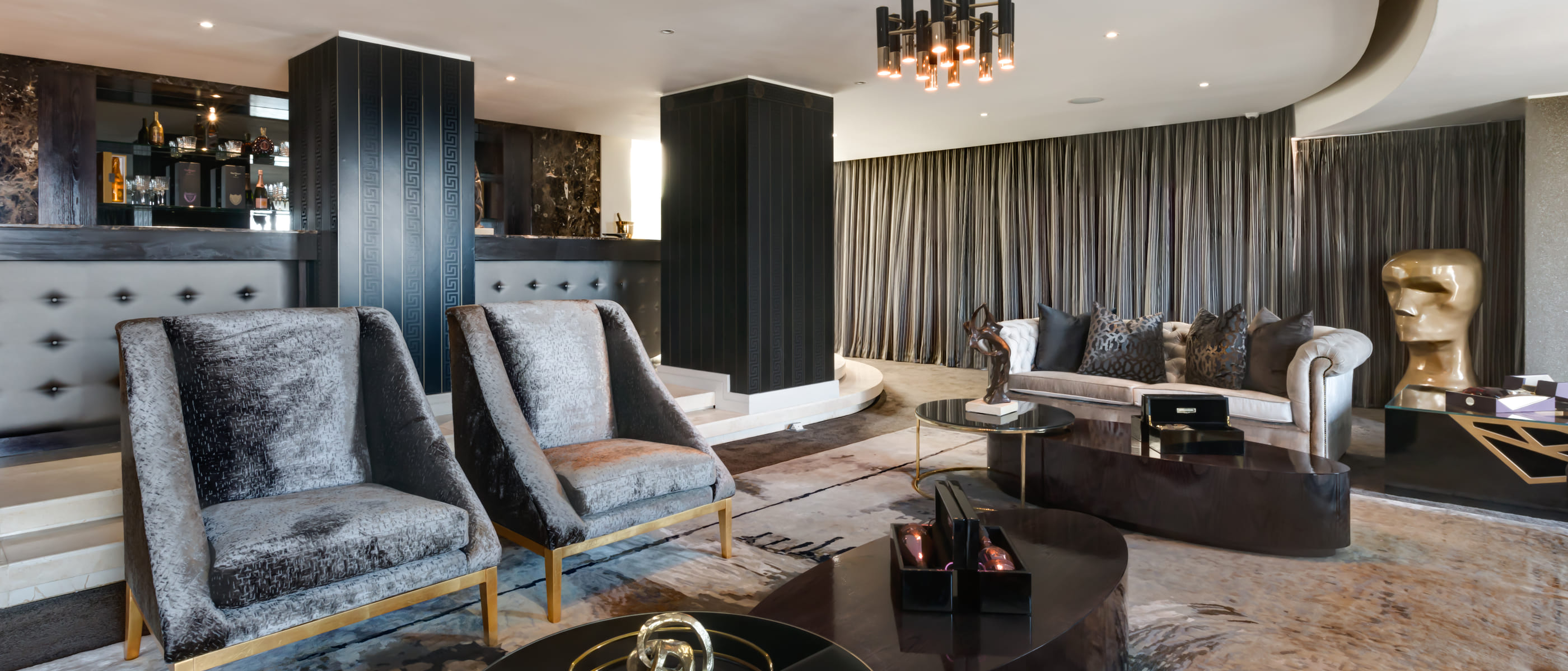 Lounge and library with full-height cabinetry and layered seating