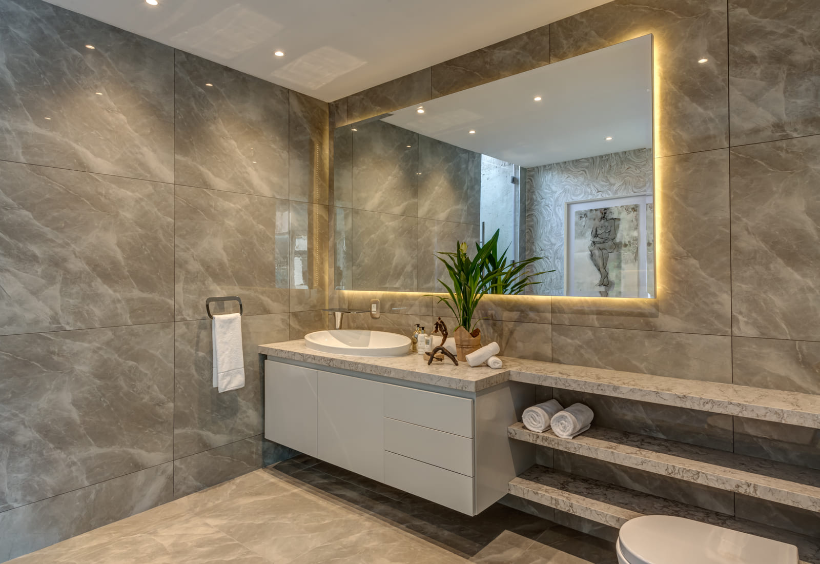 Master en-suite with backlit mirrors and a stone vanity