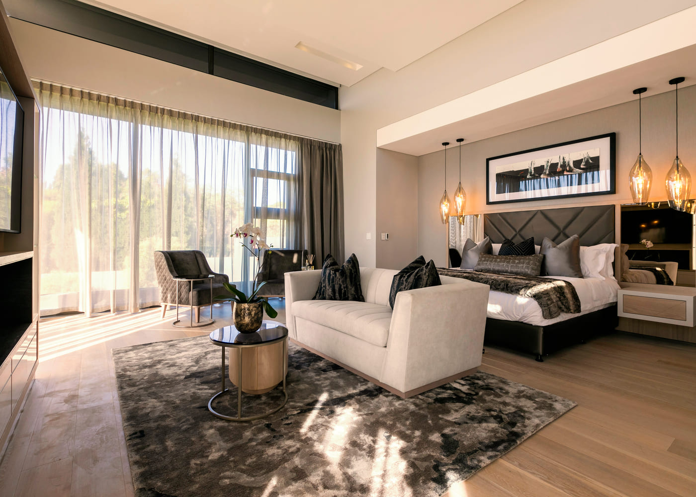 Principal bedroom with bespoke headboard wall and seating