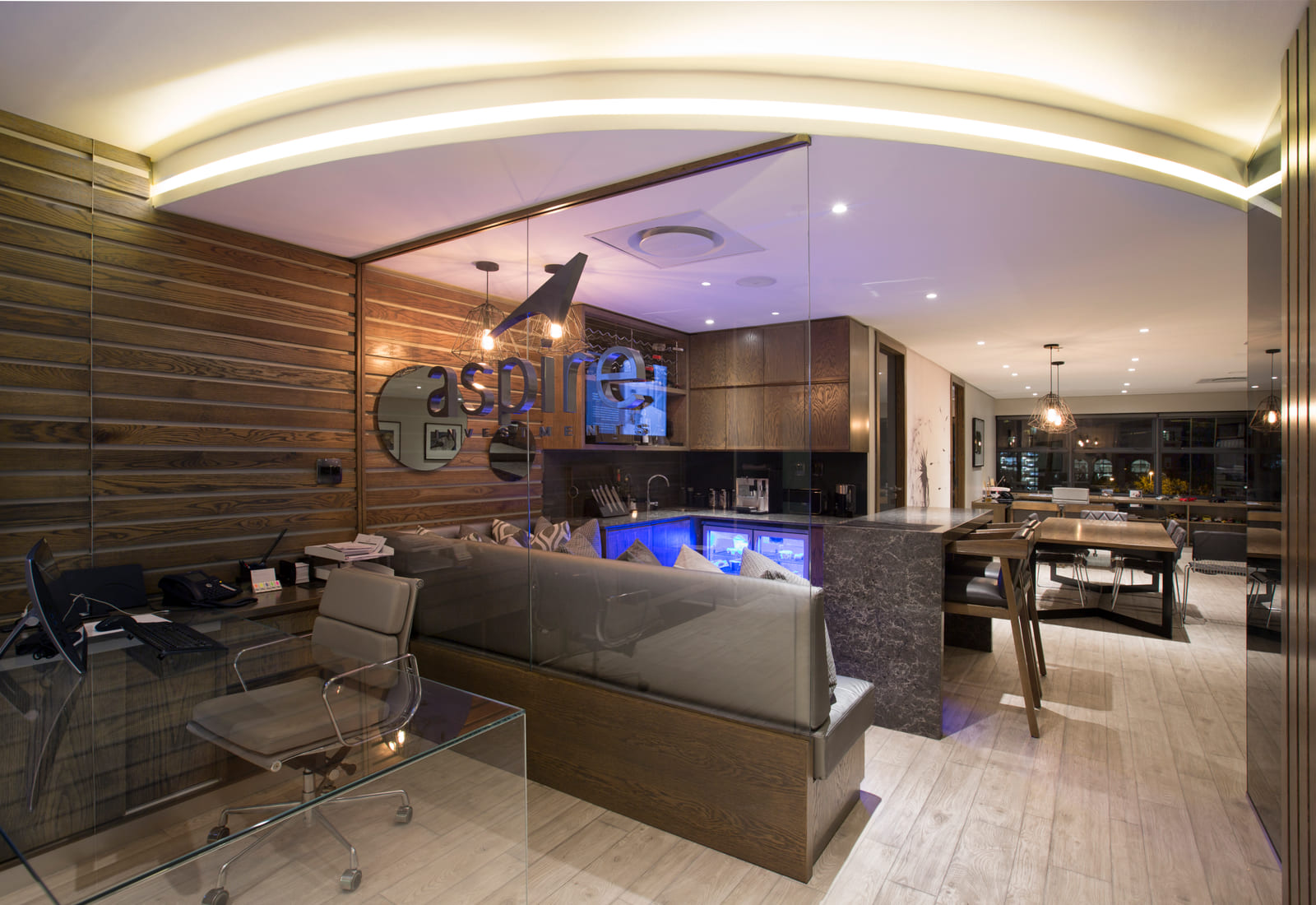 Bar and lounge with curved lighting, stone and timber detailing
