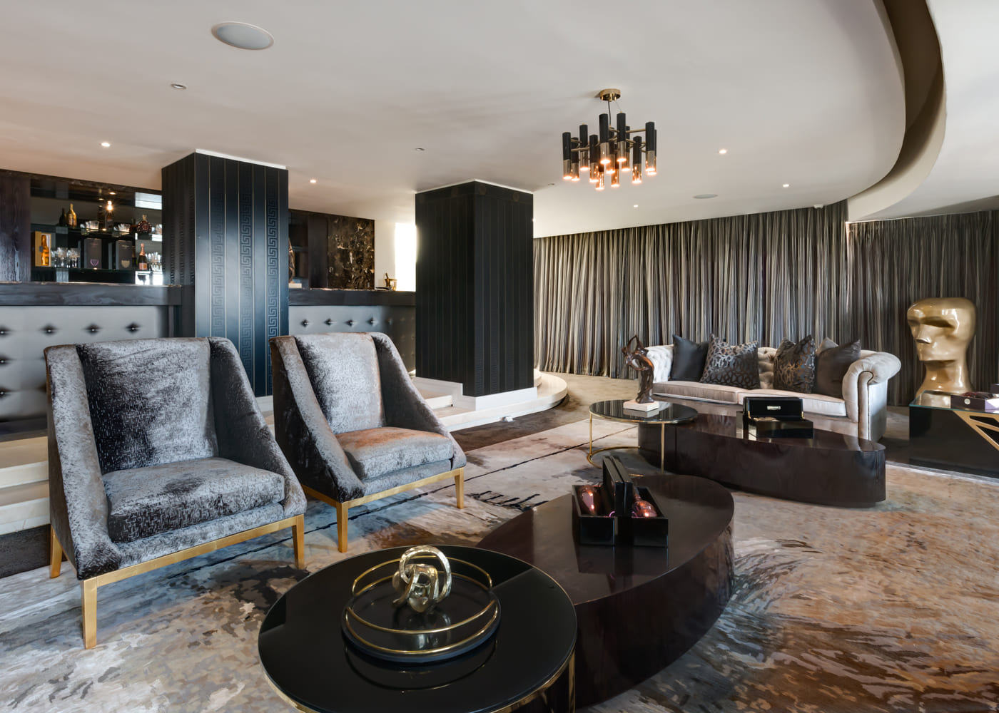 Lounge and library with full height cabinetry and deep seating